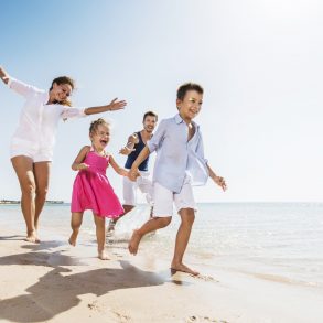 Family running on beach