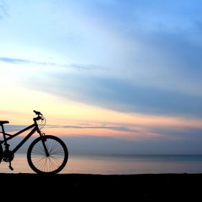 One of the best 30A bike trails with a bike against a sunset background