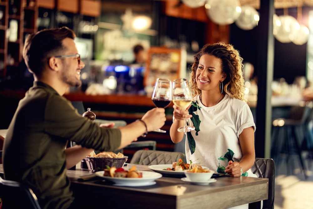 Happy couple toasting with wine during lunch in a restaurant