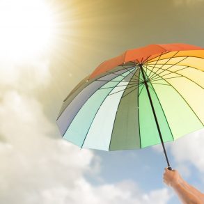 Rainbow colored umbrella; Things to Do at the Beach When it Rains