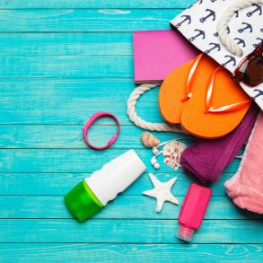 Beach Bag Accessories on a Blue Wooden Table