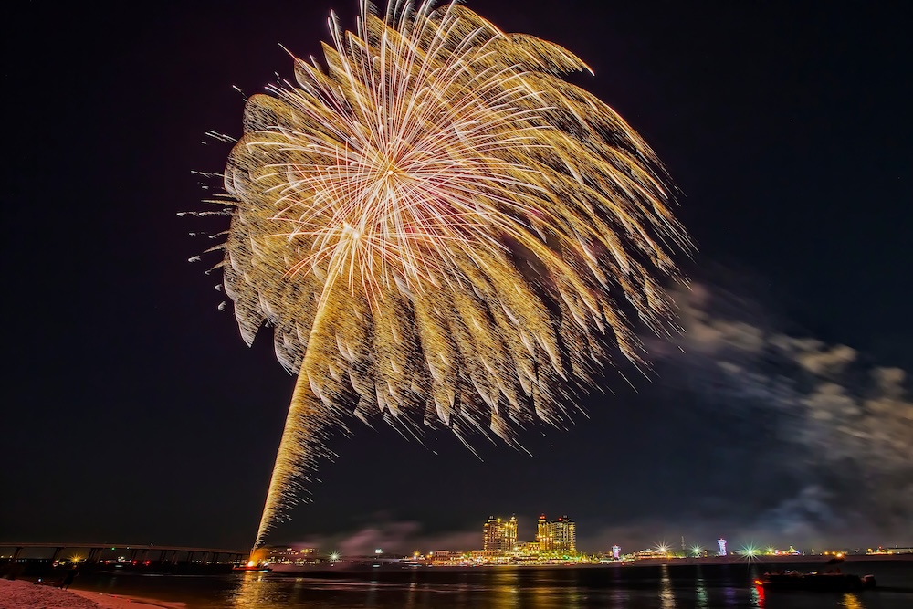 Fireworks display being shot off in the channel by Harborwalk Village in Destin Florida.