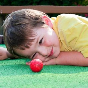 child playing mini golf