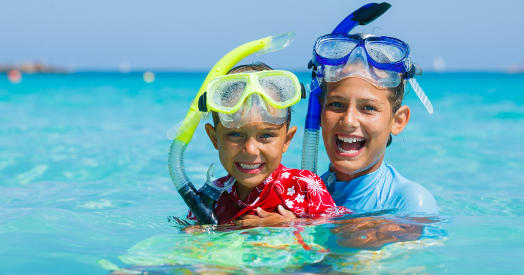 two children smiling with snorkel masks