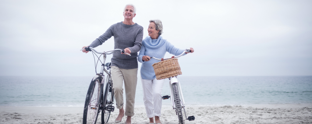 couple with bikes on the beach