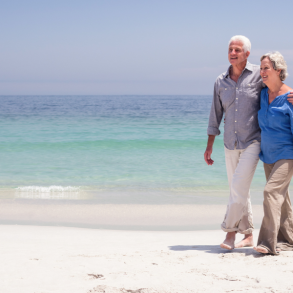 older couple walking on beach