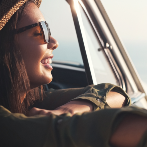 woman enjoying view from car